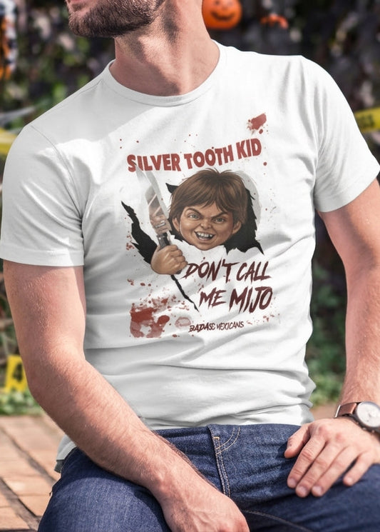 White graphic t-shirt featuring a creepy killer doll parody tearing through a wall with text reading "SILVER TOOTH KID DON'T CALL ME MIJO".