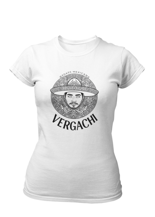 A white t-shirt featuring a large black graphic. The design includes a circular Aztec calendar-style background with a stylized man wearing a traditional Mexican charro hat in the center. The word "VERGACHI" is printed in a bold, arched serif font underneath the graphic, with "BADASS MEXICANS" in a small arch above it.