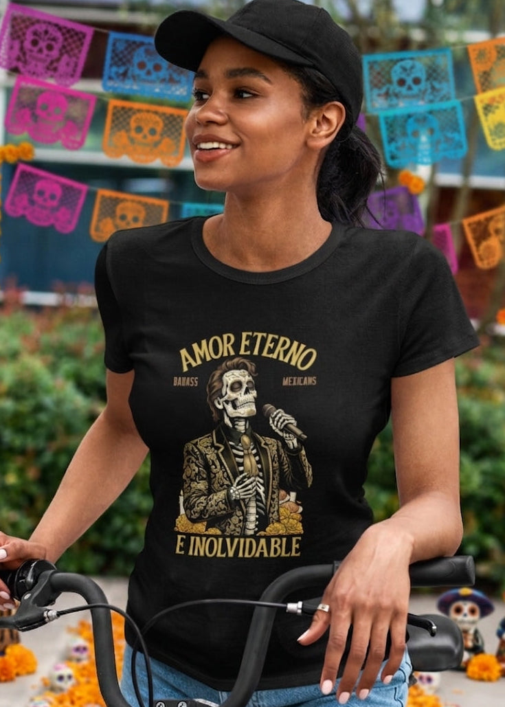 Black t-shirt featuring a detailed Catrín graphic of Juan Gabriel holding a microphone surrounded by golden text reading "AMOR ETERNO E INOLVIDABLE".