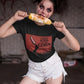 Black crew-neck t-shirt featuring a red retro movie poster graphic with a hand holding a spiced corn on a stick above a cornfield silhouette.