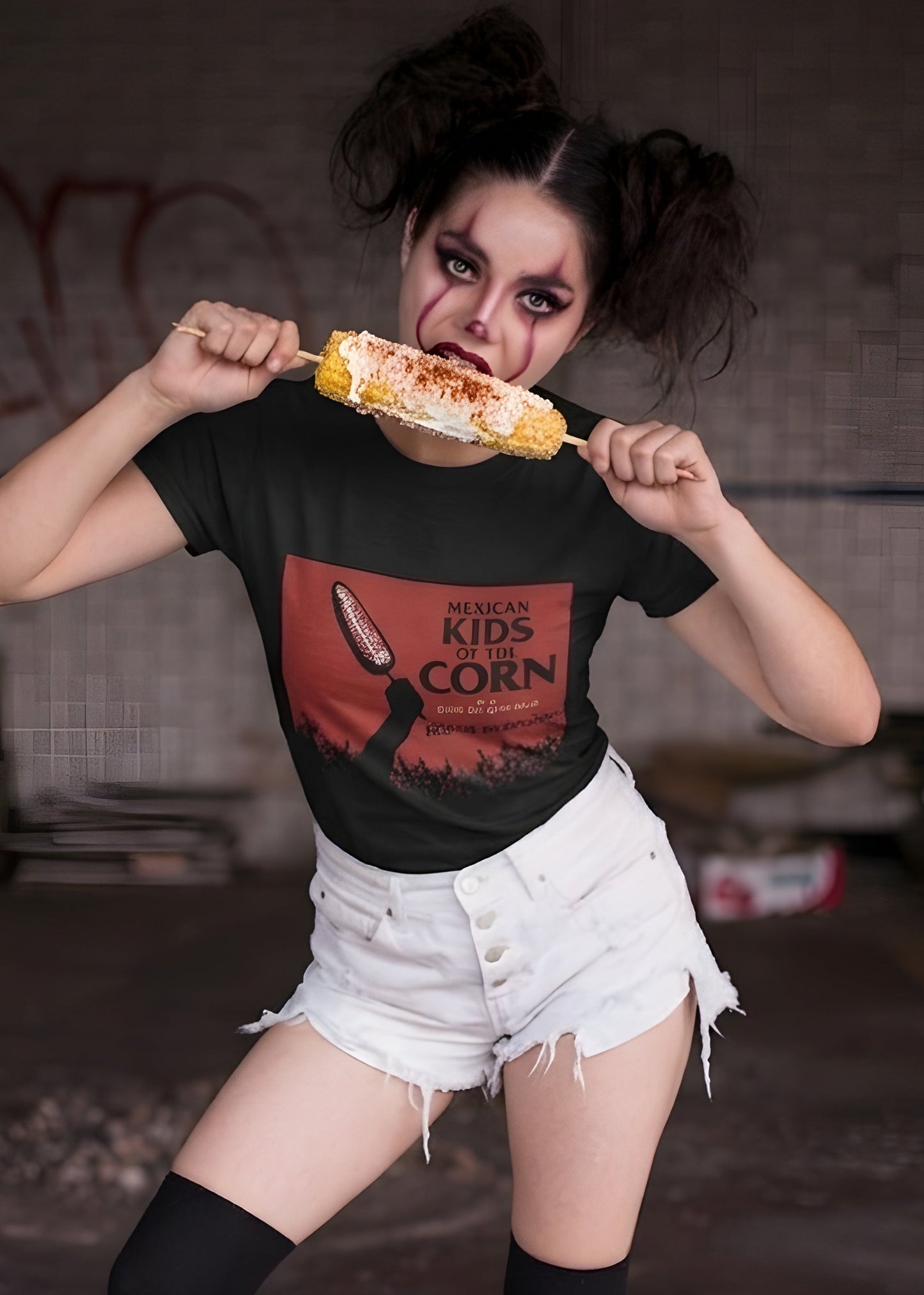 Black crew-neck t-shirt featuring a red retro movie poster graphic with a hand holding a spiced corn on a stick above a cornfield silhouette.