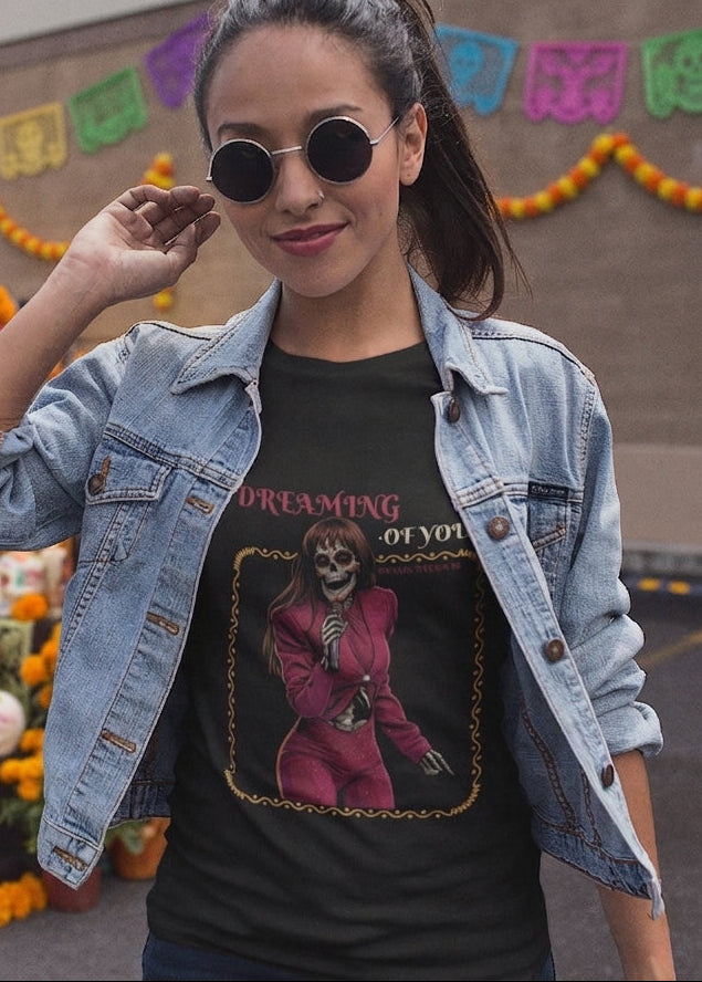 Black fitted women's t-shirt with a vintage graphic of a skeleton singer in a purple jumpsuit with the text "DREAMING OF YOU".