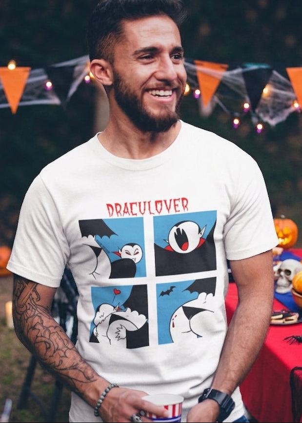White t-shirt featuring a red "DRACULOVER" title above a 4-panel comic graphic of a cartoon vampire biting a lower back.