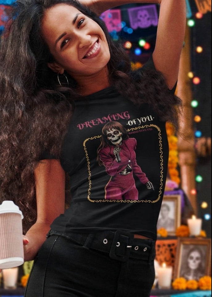 Black fitted women's t-shirt with a vintage graphic of a skeleton singer in a purple jumpsuit with the text "DREAMING OF YOU".