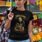 Black t-shirt featuring a detailed Catrín graphic of Juan Gabriel holding a microphone surrounded by golden text reading "AMOR ETERNO E INOLVIDABLE".