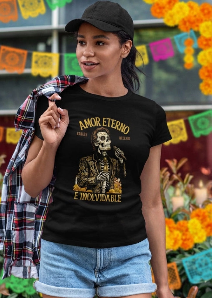 Black t-shirt featuring a detailed Catrín graphic of Juan Gabriel holding a microphone surrounded by golden text reading "AMOR ETERNO E INOLVIDABLE".