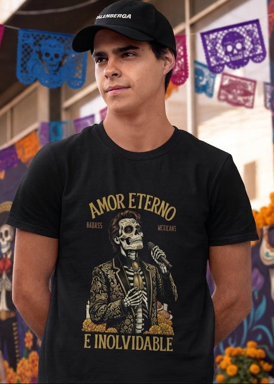 Black t-shirt featuring a detailed Catrín graphic of Juan Gabriel holding a microphone surrounded by golden text reading "AMOR ETERNO E INOLVIDABLE".