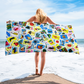 mexican loteria inspired beach towel with colorful collage of traditional card-style illustrations for summer pool and beach use
