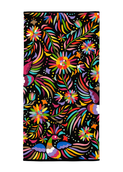 otomi inspired black beach towel with colorful birds flowers and mexican folk art style design on dark background