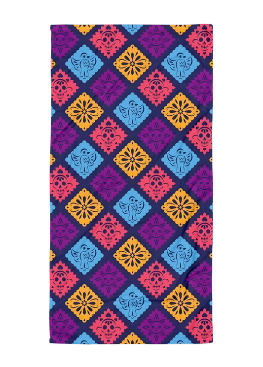 purple papel picado inspired beach towel with colorful skulls suns birds and floral shapes in mexican folk art style