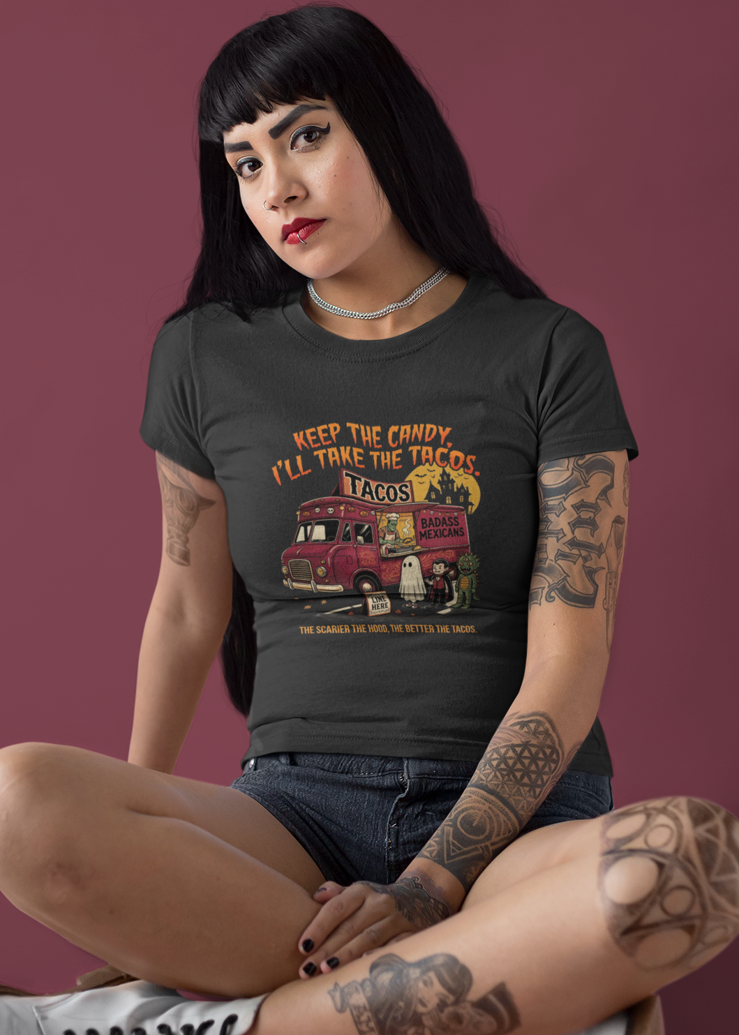 Black t-shirt featuring a spooky taco truck graphic with monsters in line under the text "Keep the candy I'll take the tacos".