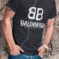 cropped-face-mockup-of-a-man-wearing-a-crew-neck showing a close-up, front view of a premium black graphic t-shirt. On the center of the chest, a large white logo features two "B" characters mirrored and interlocked back-to-back. Directly below the logo, the word "BALENBERGA" is printed in an edgy, stylized white paint-stroke font, with "BADASS MEXICANS" cleanly written underneath in a small, minimalist font.