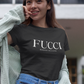 A Black lifestyle t-shirt featuring the word "FUCCI" printed in a large, elegant White serif font across the chest. Below it, the brand name "BADASS MEXICANS" is printed in a smaller, clean sans-serif font.