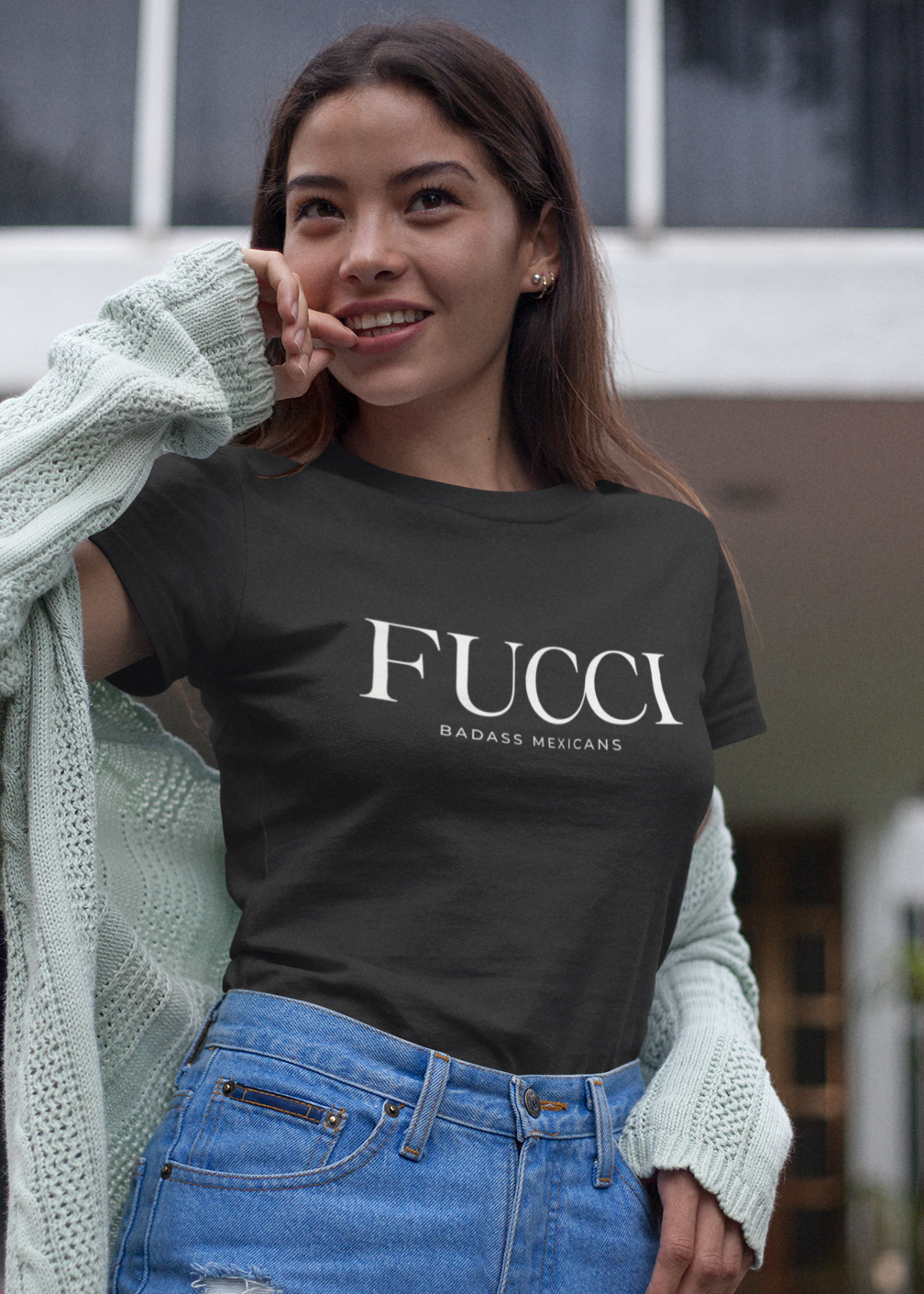A Black lifestyle t-shirt featuring the word "FUCCI" printed in a large, elegant White serif font across the chest. Below it, the brand name "BADASS MEXICANS" is printed in a smaller, clean sans-serif font.