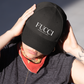 showing a close-up, front-facing view of a classic black dad hat. The word "FUCCI" is prominently embroidered across the front panel in a large, elegant white serif font, with the words "BADASS MEXICANS" stitched right below it in a smaller, clean sans-serif typeface.