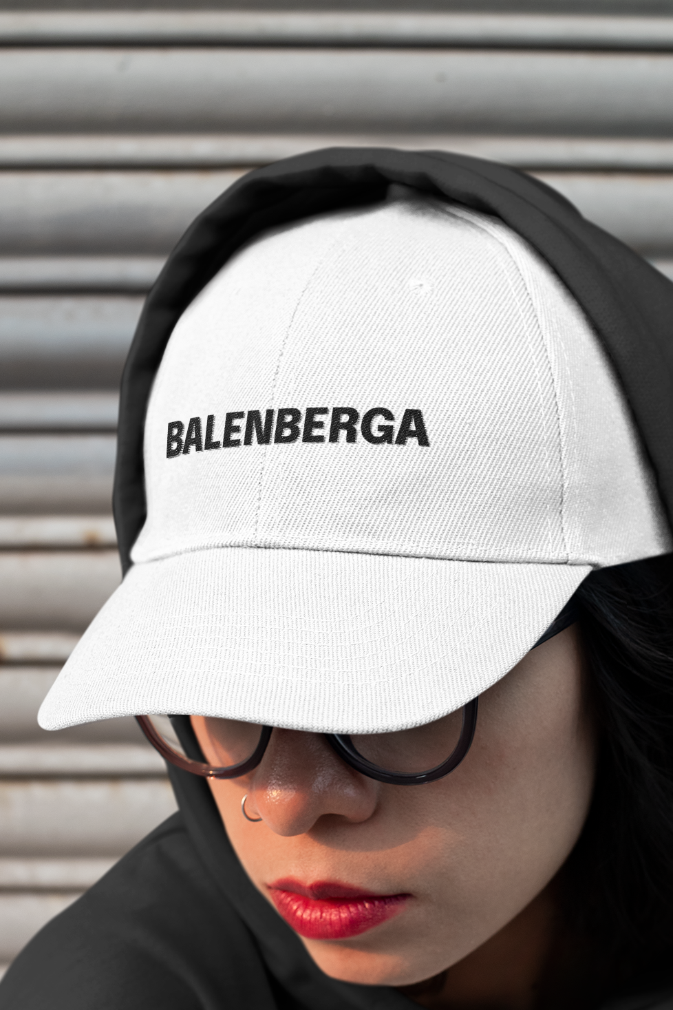 White dad hat style cap, embroidered with the legend BALENBERGA