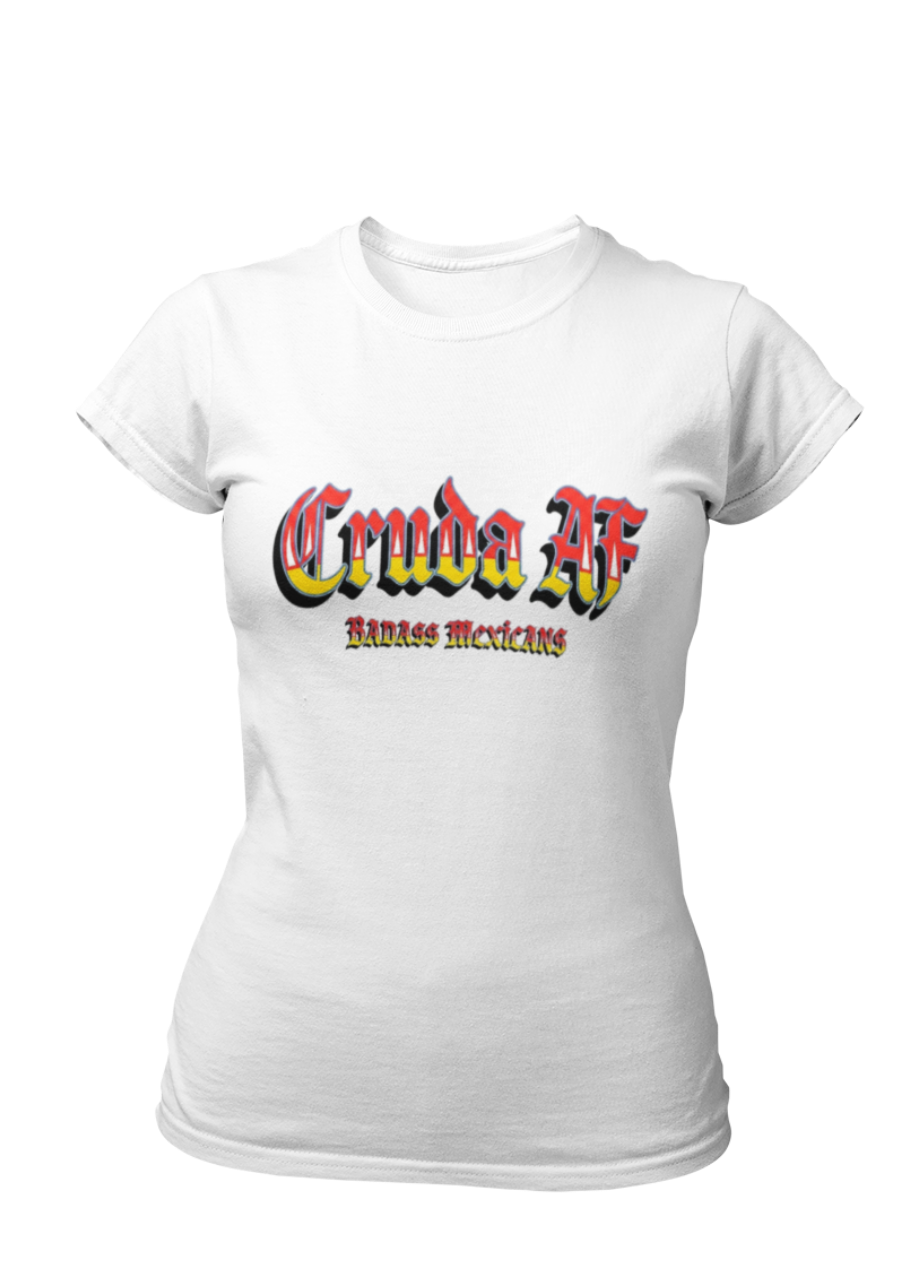 A white fitted women's crew-neck t-shirt featuring the text "Cruda AF" printed across the chest in a bold, stylized Gothic font. The letters feature a horizontal color gradient transition from red at the top, fading into yellow and white at the bottom, outlined in black with a heavy black drop shadow. Directly below, the words "BADASS MEXICANS" are printed in a smaller, matching Gothic font with the same red, yellow, and white gradient and drop shadow effect.