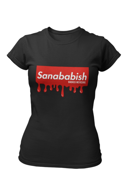 A black crew-neck t-shirt featuring a solid red rectangular box graphic on the chest. Inside the box, the word "Sanababish" is printed in a bold white, slanted font, with the words "BADASS MEXICANS" in smaller white letters beneath it. The bottom edge of the red box is styled to look like wet paint, with thick red droplets dripping down onto the fabric.