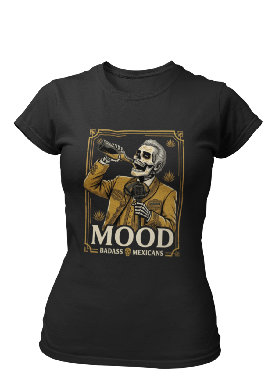 A high-quality graphic on a black t-shirt featuring a skeleton dressed in a traditional gold and brown Mariachi suit. The skeleton is holding a vintage microphone and drinking from a bottle. The design is framed in an elegant vintage border with the word "MOOD" in large serif letters and "BADASS MEXICANS" underneath.