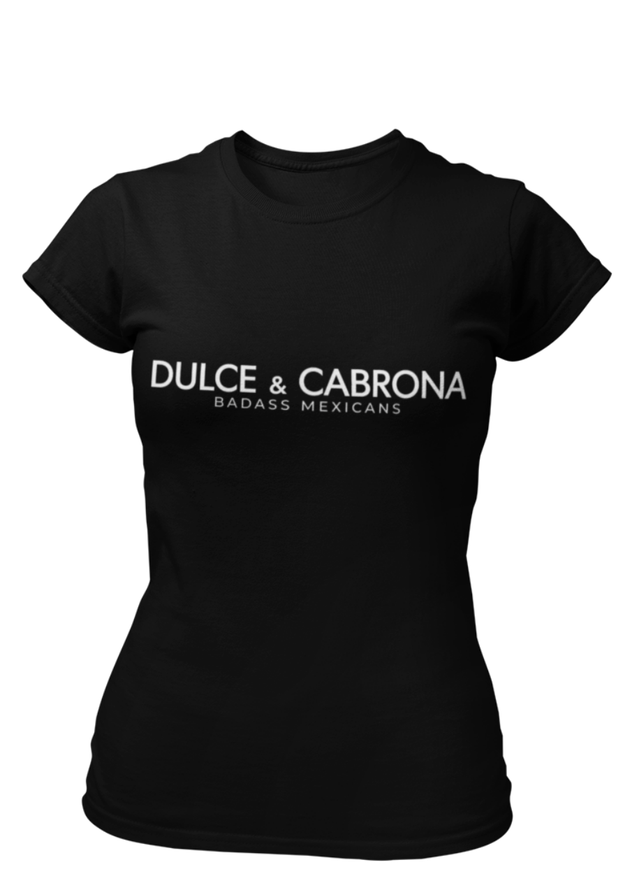 A fitted black women's t-shirt with the words "DULCE & CABRONA" printed in a clean, white luxury-style font. Below the main text, "BADASS MEXICANS" is printed in a smaller, secondary font.