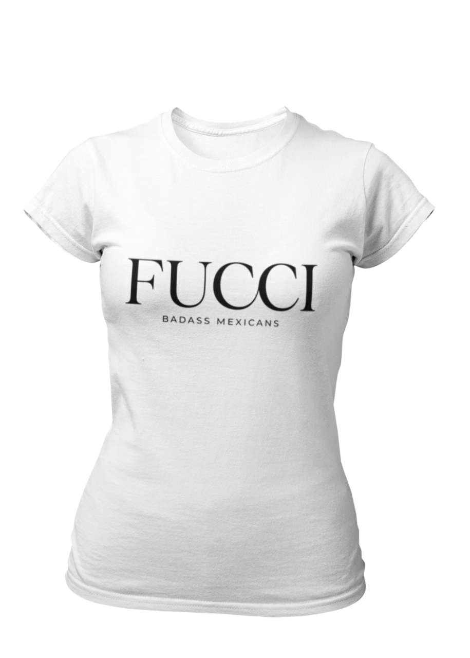 A white lifestyle t-shirt featuring the word "FUCCI" printed in a large, elegant black serif font across the chest. Below it, the brand name "BADASS MEXICANS" is printed in a smaller, clean sans-serif font.