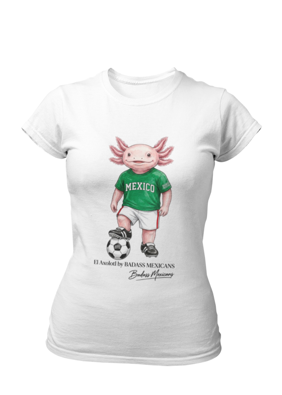 A white crew-neck t-shirt  featuring a colorful graphic illustration of a cute pink axolotl character dressed in a green Mexico soccer jersey, white shorts, and soccer cleats. The axolotl is standing with one foot on a classic black and white soccer ball. Below the design, it reads "El Axolotl by BADASS MEXICANS" with a cursive signature.