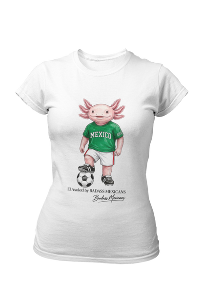 A white crew-neck t-shirt  featuring a colorful graphic illustration of a cute pink axolotl character dressed in a green Mexico soccer jersey, white shorts, and soccer cleats. The axolotl is standing with one foot on a classic black and white soccer ball. Below the design, it reads "El Axolotl by BADASS MEXICANS" with a cursive signature.