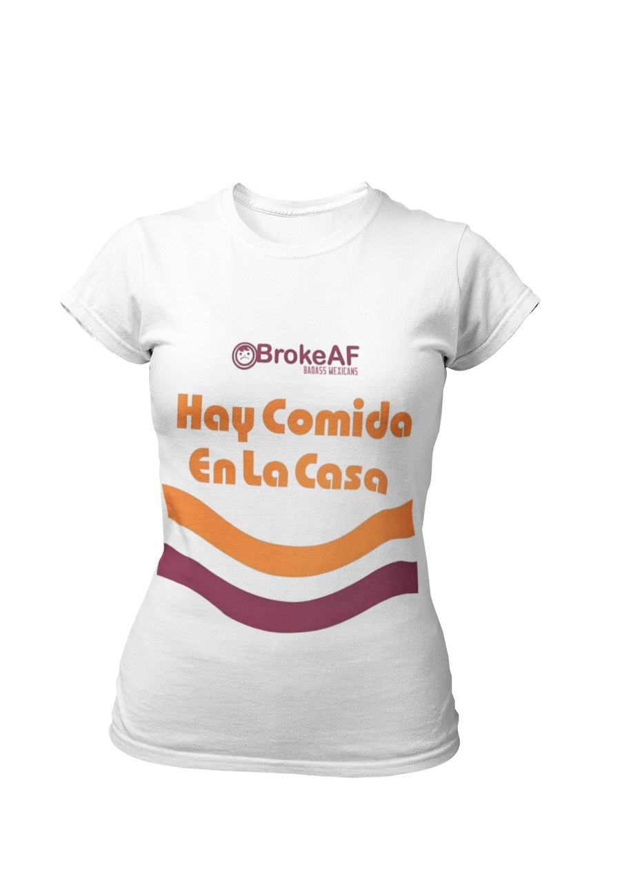White t-shirt featuring the phrase “Hay Comida En La Casa” in a retro instant noodle-inspired design with orange and brown accents.