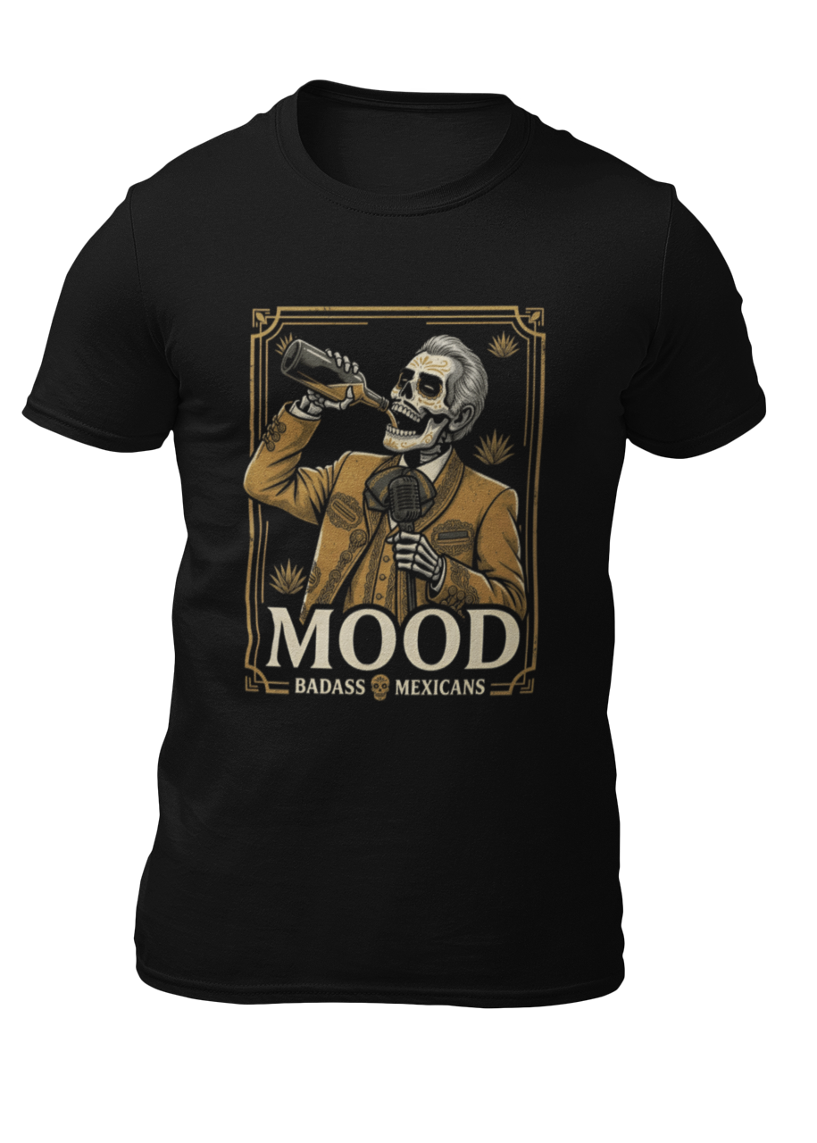 A high-quality graphic on a black t-shirt featuring a skeleton dressed in a traditional gold and brown Mariachi suit. The skeleton is holding a vintage microphone and drinking from a bottle. The design is framed in an elegant vintage border with the word "MOOD" in large serif letters and "BADASS MEXICANS" underneath.