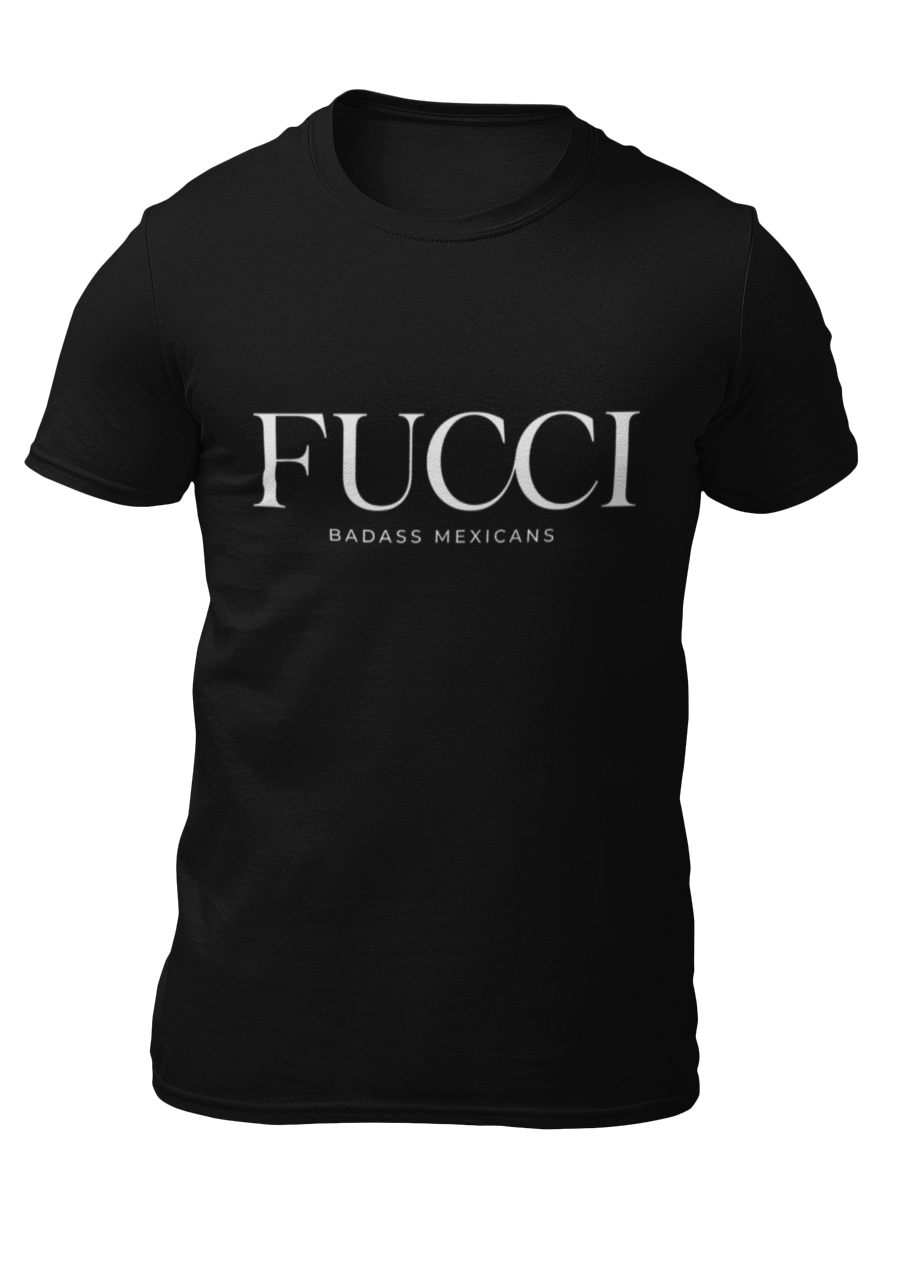 A black lifestyle t-shirt featuring the word "FUCCI" printed in a large, elegant white serif font across the chest. Below it, the brand name "BADASS MEXICANS" is printed in a smaller, clean sans-serif font.