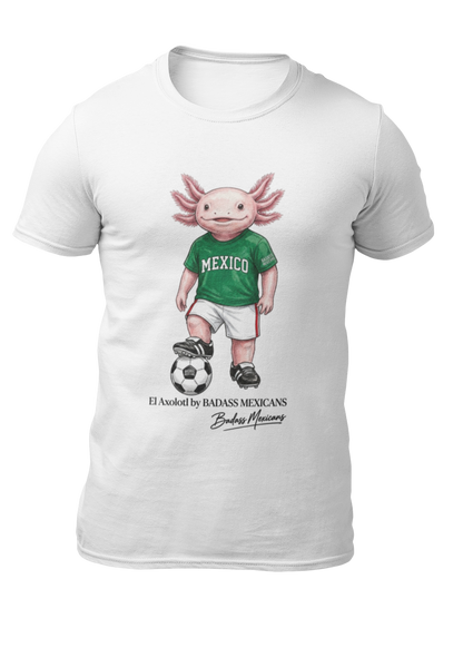 A white crew-neck t-shirt  featuring a colorful graphic illustration of a cute pink axolotl character dressed in a green Mexico soccer jersey, white shorts, and soccer cleats. The axolotl is standing with one foot on a classic black and white soccer ball. Below the design, it reads "El Axolotl by BADASS MEXICANS" with a cursive signature.