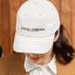 white dad hat On the front panel of the hat, the words "DULCE & CABRONA" are printed in a clean black luxury-style serif font, with "BADASS MEXICANS" printed right underneath in a smaller size.