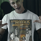White t-shirt featuring a spooky band parody with ghosts around a fireplace with text reading "LOS BOOOKIS".