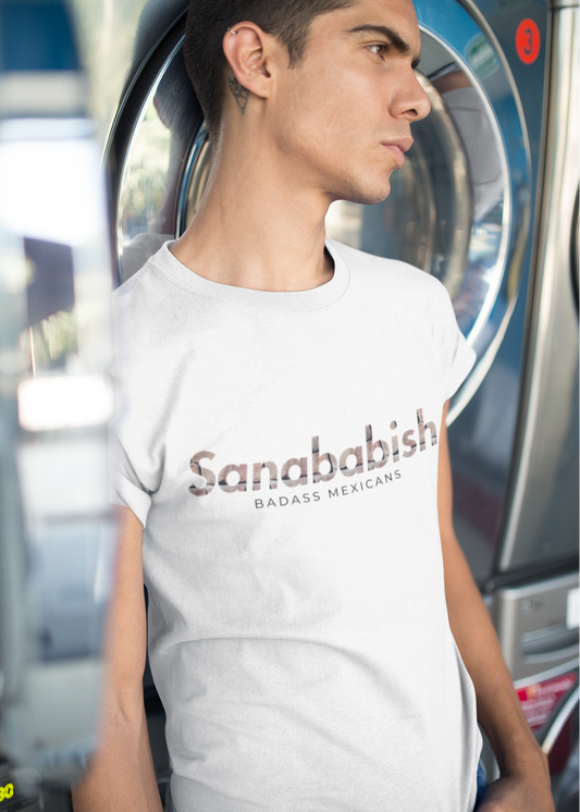White crew-neck t-shirt with "Sanababish" printed across the chest in a stylized font with a bricks textured pattern, and "BADASS MEXICANS" in small black text below.
