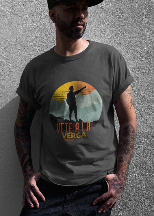 Black crew-neck t-shirt with a colorful retro circular sunset graphic showing a mountain hiker silhouette pointing forward above orange and yellow text "Vete a la verga".