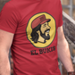 A caricature image of Mexican singer "El Buki," replacing the traditional beaver character on a stylized logo for a gas station.  all printed on a casual, short-sleeved t-shirt. The overall style is a fun, graphic illustration parody.