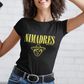 Black crew-neck t-shirt with "NI MADRES" printed in a yellow grunge font above a yellow line-art icon of a smiling man wearing a traditional sombrero.