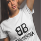 front view of a premium white graphic t-shirt. On the center of the chest, a large black logo features two "B" characters mirrored and interlocked back-to-back. Directly below the logo, the word "BALENBERGA" is printed in an edgy, stylized white paint-stroke font, with "BADASS MEXICANS" cleanly written underneath in a small, minimalist font.