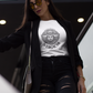 A white t-shirt featuring a large black graphic. The design includes a circular Aztec calendar-style background with a stylized man wearing a traditional Mexican charro hat in the center. The word "VERGACHI" is printed in a bold, arched serif font underneath the graphic, with "BADASS MEXICANS" in a small arch above it.