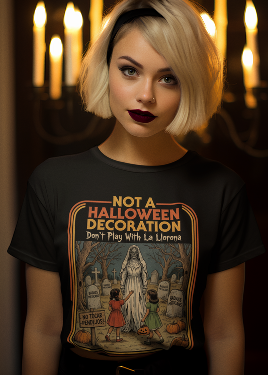 Black t-shirt featuring a retro horror poster illustration of La Llorona in a graveyard above the text "NOT A HALLOWEEN DECORATION Don't Play With La Llorona".