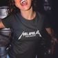 Black fitted women's crew-neck t-shirt with "MELAPELAS" printed in a sharp white heavy-metal lightning font and small white text underneath.