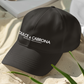black dad hat On the front panel of the hat, the words "DULCE & CABRONA" are printed in a clean white luxury-style serif font, with "BADASS MEXICANS" printed right underneath in a smaller size.