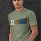 An Military green crew-neck t-shirt featuring a graphic design printed across the chest. The design consists of five vertical color blocks lined up side-by-side in white, beige, gold, blue, and dark gray. Overlaid on these blocks, the word "CHINGON" is printed in a large, elegant dark gray serif font, with the words "BADASS MEXICANS" written directly underneath in a smaller, clean sans-serif typeface.