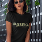 A black streetwear t-shirt showcasing the word "BALENBERGA" across the chest in a heavy, textured, geometric block font with alternating mirrored letters in an olive-beige tone. Underneath, "BADASS MEXICANS" is printed in a clean, sharp matching font.