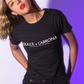 A fitted black women's t-shirt with the words "DULCE & CABRONA" printed in a clean, white luxury-style font. Below the main text, "BADASS MEXICANS" is printed in a smaller, secondary font.