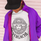 A white t-shirt featuring a large black graphic. The design includes a circular Aztec calendar-style background with a stylized man wearing a traditional Mexican charro hat in the center. The word "VERGACHI" is printed in a bold, arched serif font underneath the graphic, with "BADASS MEXICANS" in a small arch above it.
