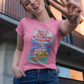 Woman wearing pink t-shirt featuring a colorful Valentine-style illustration with Spanish text that reads "Chingas a tu Madre" “Con Cariño,” designed as a humorous and playful Mexican-inspired message.