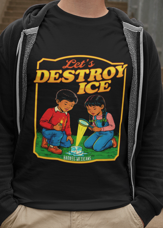 A man wearing a black t-shirt with a vintage-style illustration of a boy and a girl melting an ice cube and the phrase “Let’s Destroy ICE” in bold retro typography.
