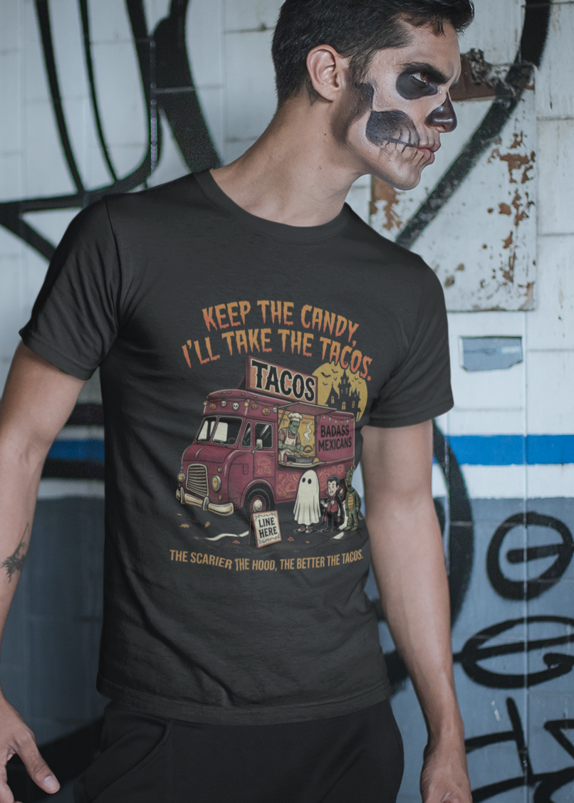 Black t-shirt featuring a spooky taco truck graphic with monsters in line under the text "Keep the candy I'll take the tacos".