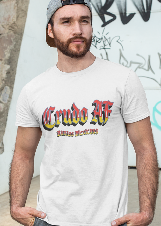 A white crew-neck t-shirt featuring the text "Crudo AF" printed across the chest in a bold, stylized Gothic font. The letters have a horizontal color gradient transition from red at the top, fading into yellow and white at the bottom, outlined in black with a heavy black drop shadow. Directly below, the words "BADASS MEXICANS" are printed in a smaller, matching Gothic font with the same red, yellow, and white gradient and drop shadow effect.